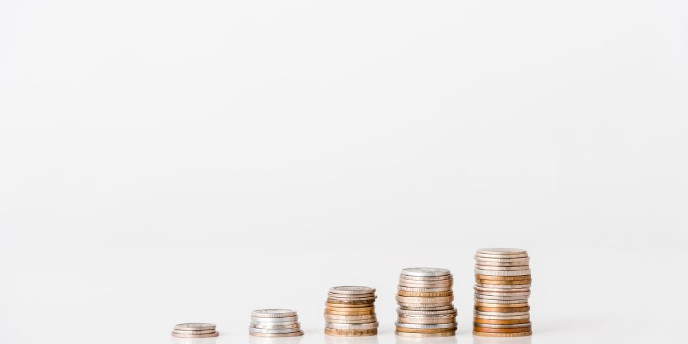 stacks of silver and golden coins on white